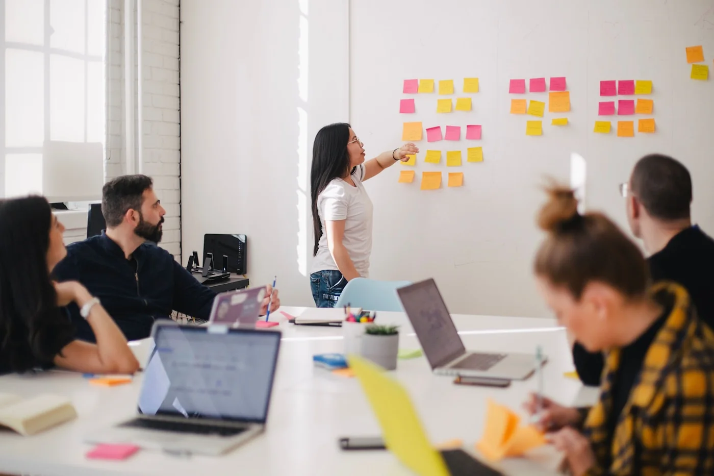 A communications team planning material together around a meeting table